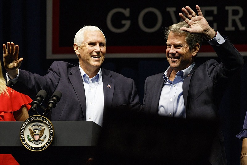 Vice President Mike Pence, left, and Republican gubernatorial candidate Brian Kemp greet the crowd during a "Get Out The Vote" rally at the Dalton Convention Center on Thursday, Nov. 1, 2018 in Dalton, Ga. Republican Brian Kemp is facing off against Democrat Stacey Abrams for governor in Georgia.
