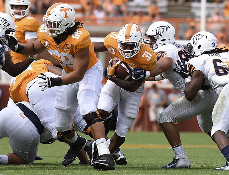 Tennessee sophomore left tackle Marcus Tatum (68) opens up a hole for running back Madre London during a home game against UTEP on Sept. 15.