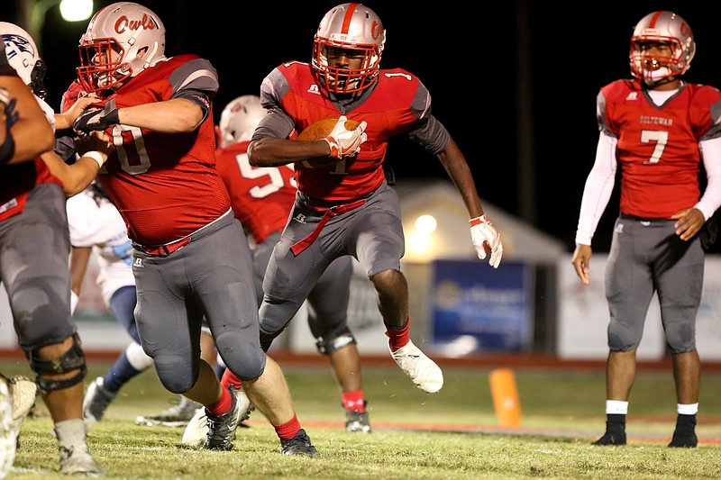 Ooltewah's Sincere Quinn (1) follows a blocker during the Owls' 35-28 win over Hardin Valley in their Class 6A state playoff game Friday night at Ooltewah.
