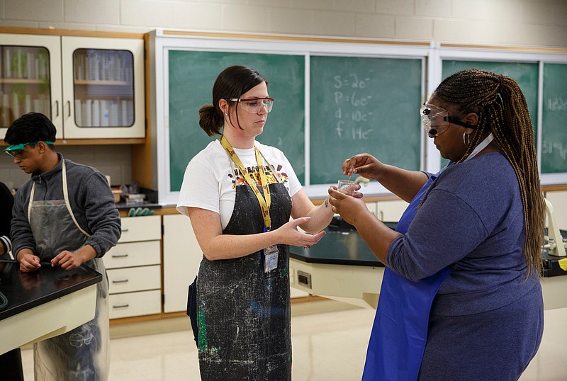 Teacher Jessica Hubbuch, center, works with student Diamond McKinley while teaching a chemistry class at Howard School on Friday, Nov. 2, 2018, in Chattanooga, Tenn. Hubbuch is also teaching AP chemistry for the first time this year.