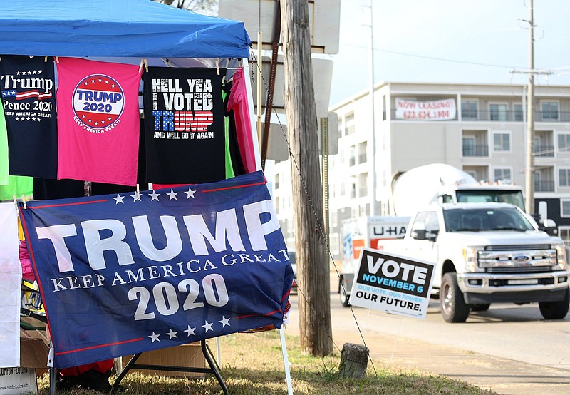 Traffic flows past a booth set up selling pro-President Donald Trump merchandise at the corner 20th Street and Broad Street Wednesday, October 31, 2018 in Chattanooga, Tennessee. Trump will be in town Sunday for a rally.