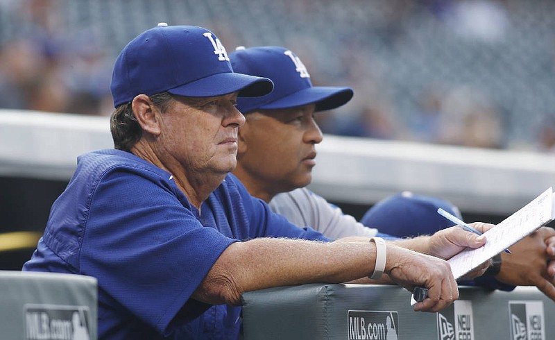 Los Angeles pitching coach Rick Honeycutt, left, and manager Dave Roberts have helped the Dodgers make consecutive trips to the World Series.