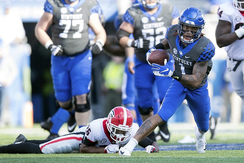 AP photo by Bryan Woolston / Kentucky wide receiver Lynn Bowden Jr. leaves a Georgia defender behind during an SEC East matchup in November 2018 in Lexington, Ky.