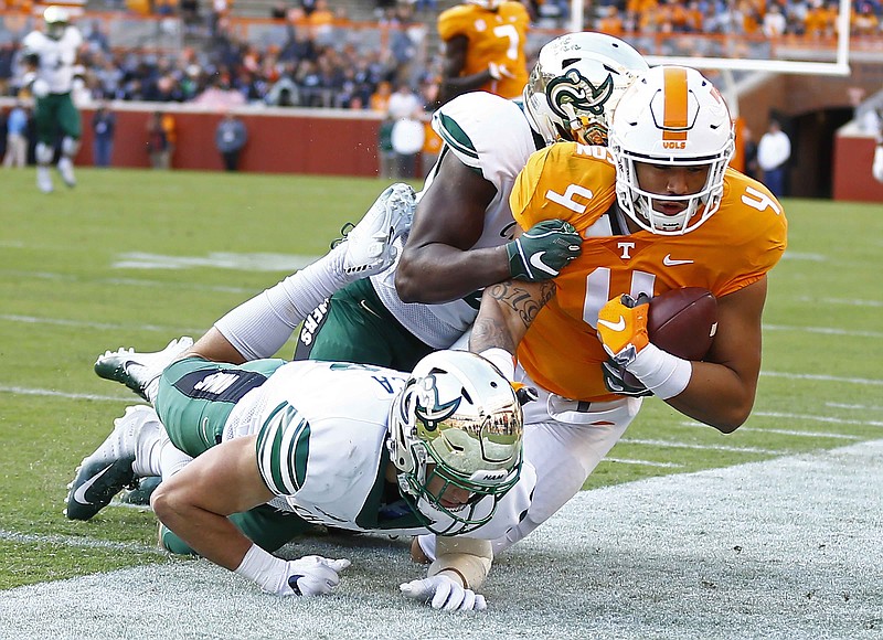Tennessee tight end Dominick Wood-Anderson is knocked out of bounds by a pair of Charlotte defenders during Saturday's game at Neyland Stadium.