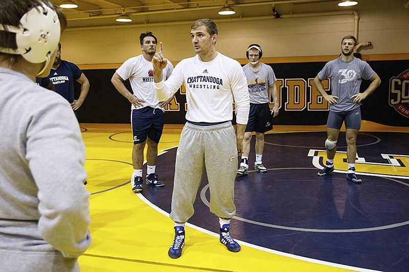 UTC wrestling coach Kyle Ruschell talks to his team during a practice in September. The Mocs open the season today at Virginia Tech's Hokie Open.