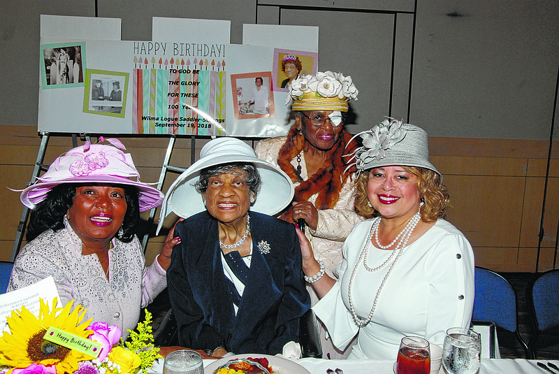 People from across the country come to celebrate Wilma L. Scruggs' 100th birthday. From left are the Rev. Eva Nell Settles, Scruggs, Jamie Winfrey and, standing, Jackie Brown.
