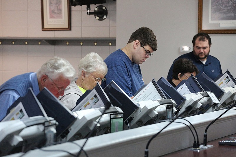 Voters mark their ballots at the voting machines Tuesday, November 6, 2018 at the Chickamauga Public Library in Chickamauga, Georgia.