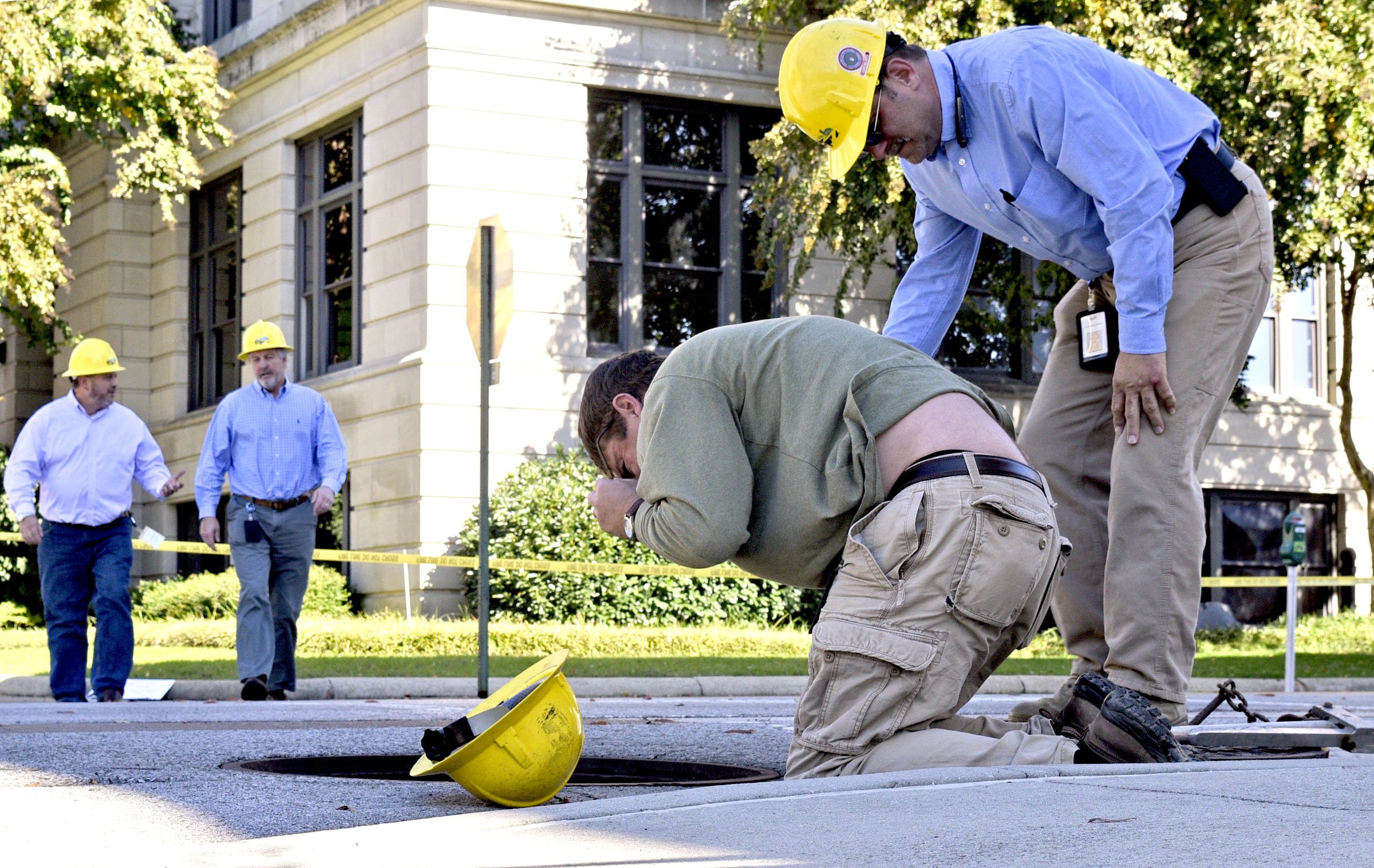 Electric Power Board personal examine the scene of a underground electrical fire near City Hall. A underground electrical fire lead to evacuations and road closers at the corner of East 11th Street and Lindsay Street by City Hall on November 6, 2018.