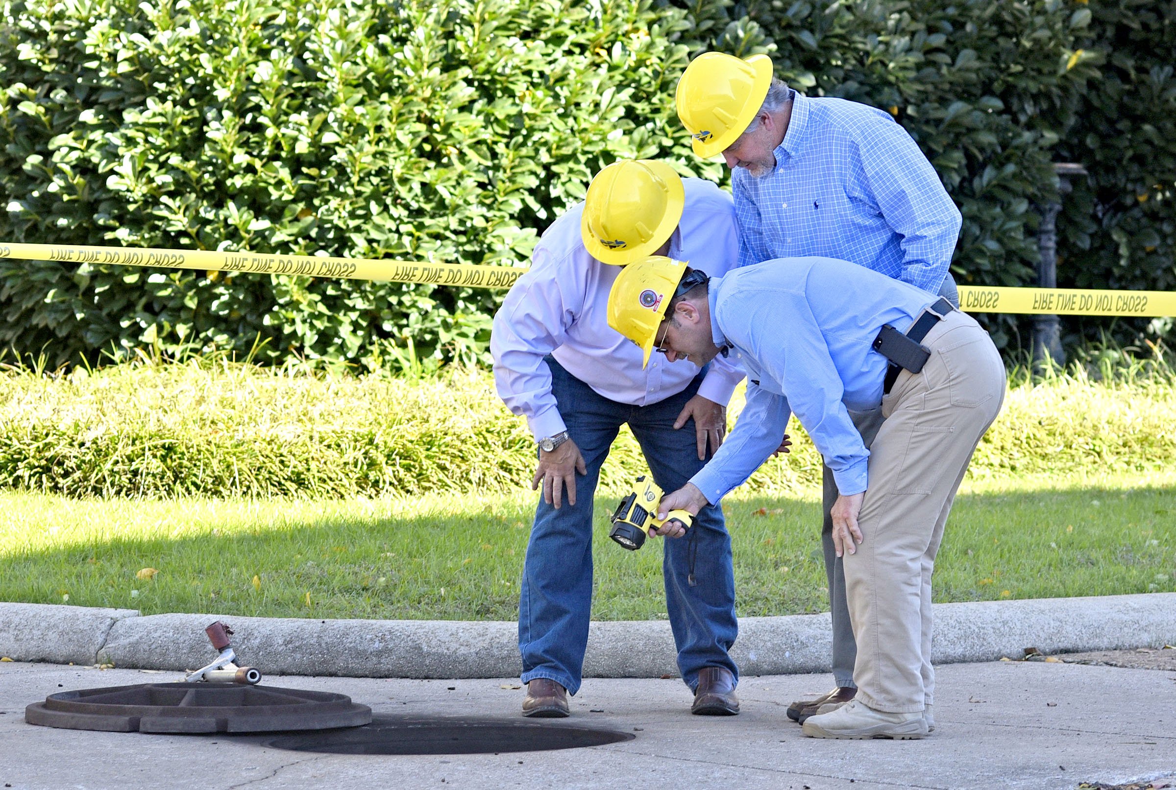 Electric Power Board personal examine the scene of a underground electrical fire near City Hall. A underground electrical fire lead to evacuations and road closers at the corner of East 11th Street and Lindsay Street by City Hall on November 6, 2018.