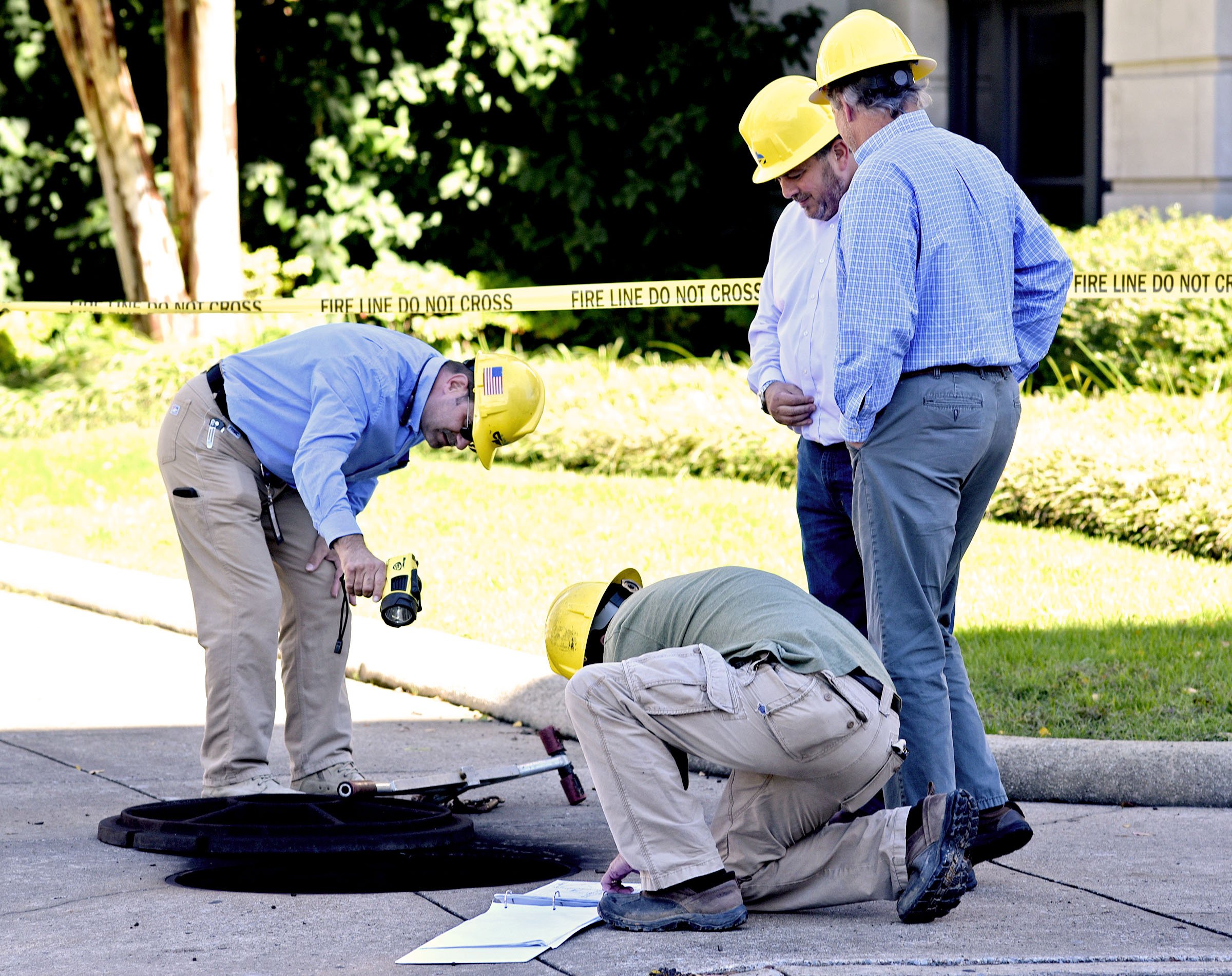 Electric Power Board personal examine the scene of a underground electrical fire near City Hall. A underground electrical fire lead to evacuations and road closers at the corner of East 11th Street and Lindsay Street by City Hall on November 6, 2018.