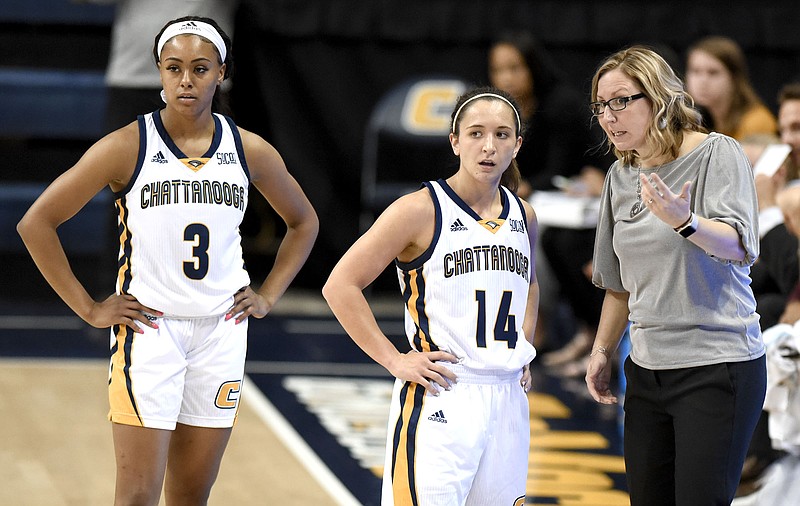 UTC women's basketball coach Katie Burrows confers with Molly Melton (14) and Mya Long (3) during a home game against Lee on Nov. 6.