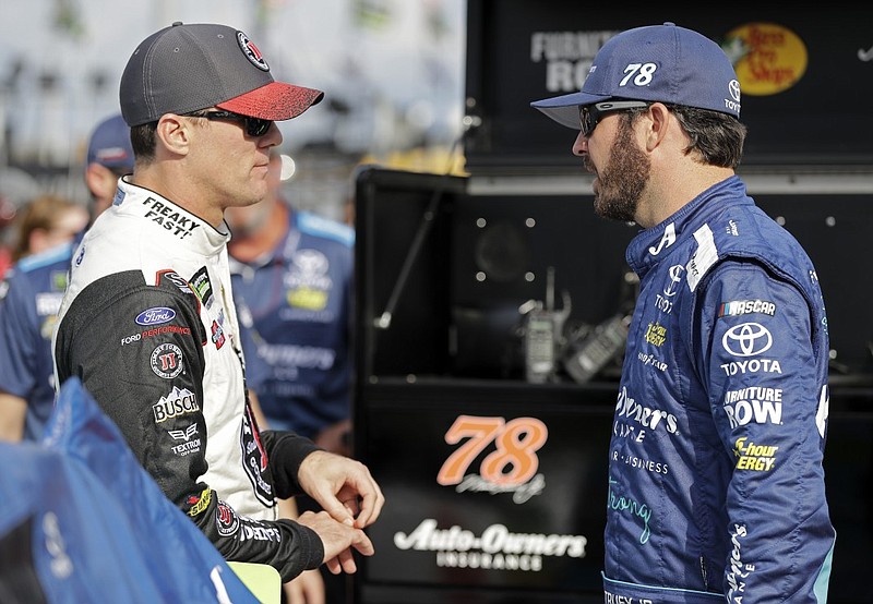 Kevin Harvick, left, talks with fellow NASCAR Cup Series driver Martin Truex Jr. before qualifying Sept. 28 at Charlotte Motor Speedway in Concord, N.C.