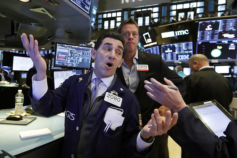 Specialist Peter Mazza, left, works on the floor of the New York Stock Exchange, Wednesday, Nov. 7, 2018. Stocks are climbing in early trading on Wall Street as results of the U.S. midterm elections came in as investors had expected. (AP Photo/Richard Drew)