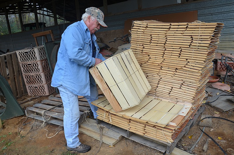 Thomas Stockburger of the Triple "S" Quail Farm and Hunting Preserve puts together a wooden crate that is used in transporting bobwhite quail raised on his farm near Ringgold. Each crate holds about 24 quail.