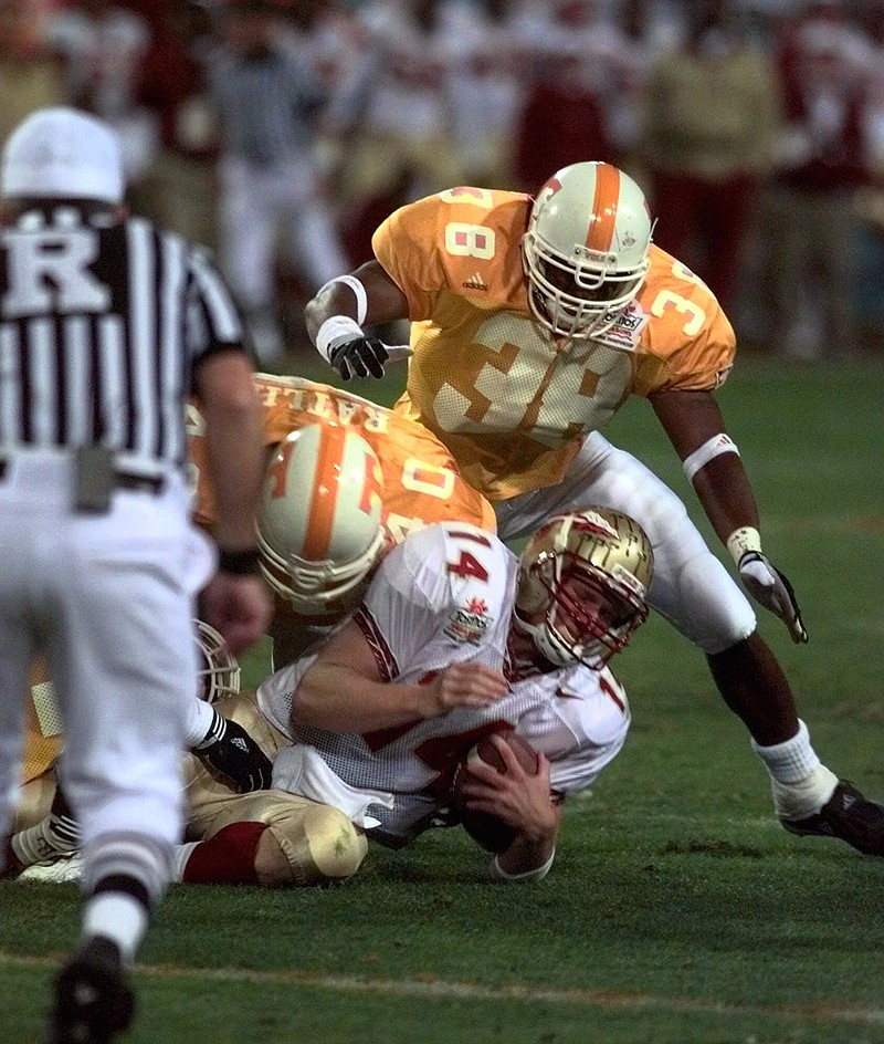 Florida State quarterback Marcus Outzen is sacked by Tennessee's Roger Alexander, top, and Billy Ratliff during the Fiesta Bowl on Jan. 4, 1999, at Sun Devil Stadium in Tempe, Ariz. The Vols won the BCS national championship that night, and Ratliff helped them get to that point undefeated with his heads-up fumble recovery against Arkansas on Nov. 14, 1998, during the regular season.