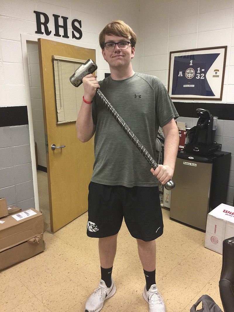 John Klein, of Ridgeland High School, shows off a custom-made sledgehammer donated for a Special Olympics fundraiser. 