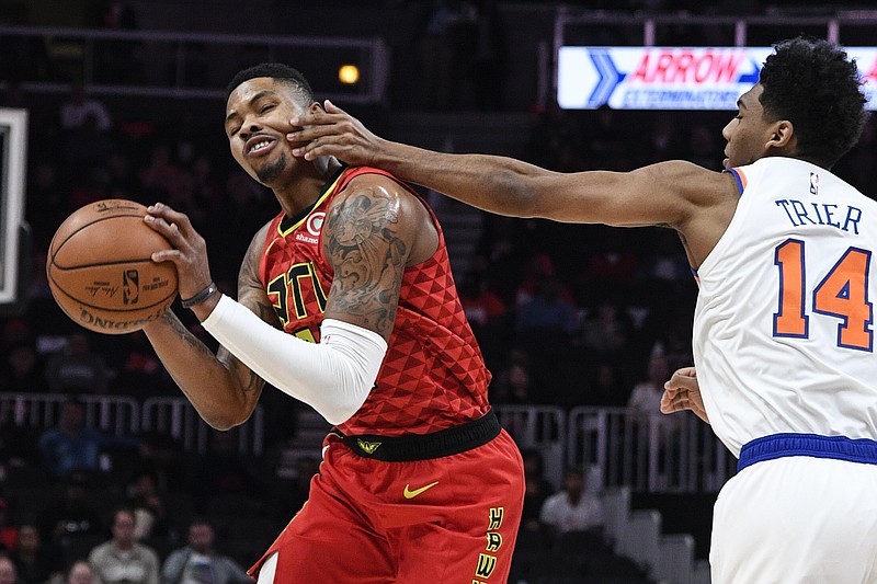 Atlanta Hawks guard Kent Bazemore gets fouled by New York Knicks guard Allonzo Trier during the first half of Wednesday's game in Atlanta.