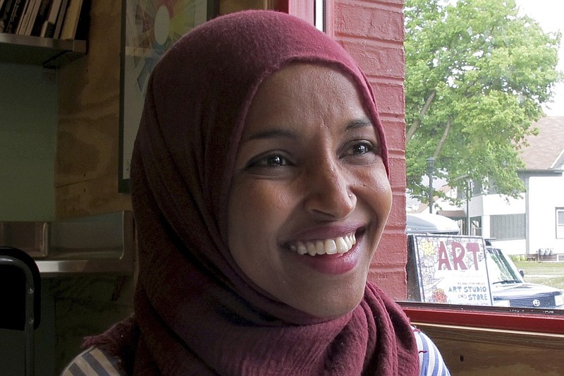 FILE - In this Aug. 16, 2018 file photo, Democrat Ilhan Omar, the nation's first Somali-American legislator who won her party's congressional primary in the race, talks during an interview at Peace Coffee in Minneapolis. Omar faces Republican candidate Jennifer Zielinski in the Nov 6 election. (AP Photo/Jeff Baenen, File)

