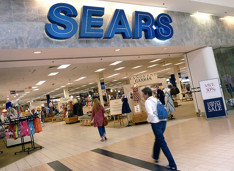 In this Monday, May 14, 2012, file photo, shoppers walk into Sears in Peabody, Mass. Sears Holdings Corp. said Friday, Dec. 6, 2013, that it will spin off its Lands' End clothing business as a separate company by distributing stock to the retailer's shareholders.  (AP Photo/Elise Amendola, File)