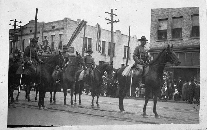 World War I troops on horseback participate in a parade on Market Street during the war.