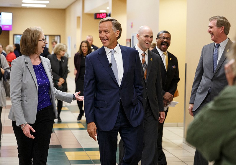 Gov. Bill Haslam speaks with Orange Grove Center Director of Adult Services Tera Roberts, left, during a visit to the campus of the University of Tennessee at Chattanooga on Thursday, Nov. 8, 2018, in Chattanooga, Tenn. Gov. Haslam released the fifth annual report by the Employment First Task Force during the visit, which shows the task force's efforts to increase employment for people with disabilities.