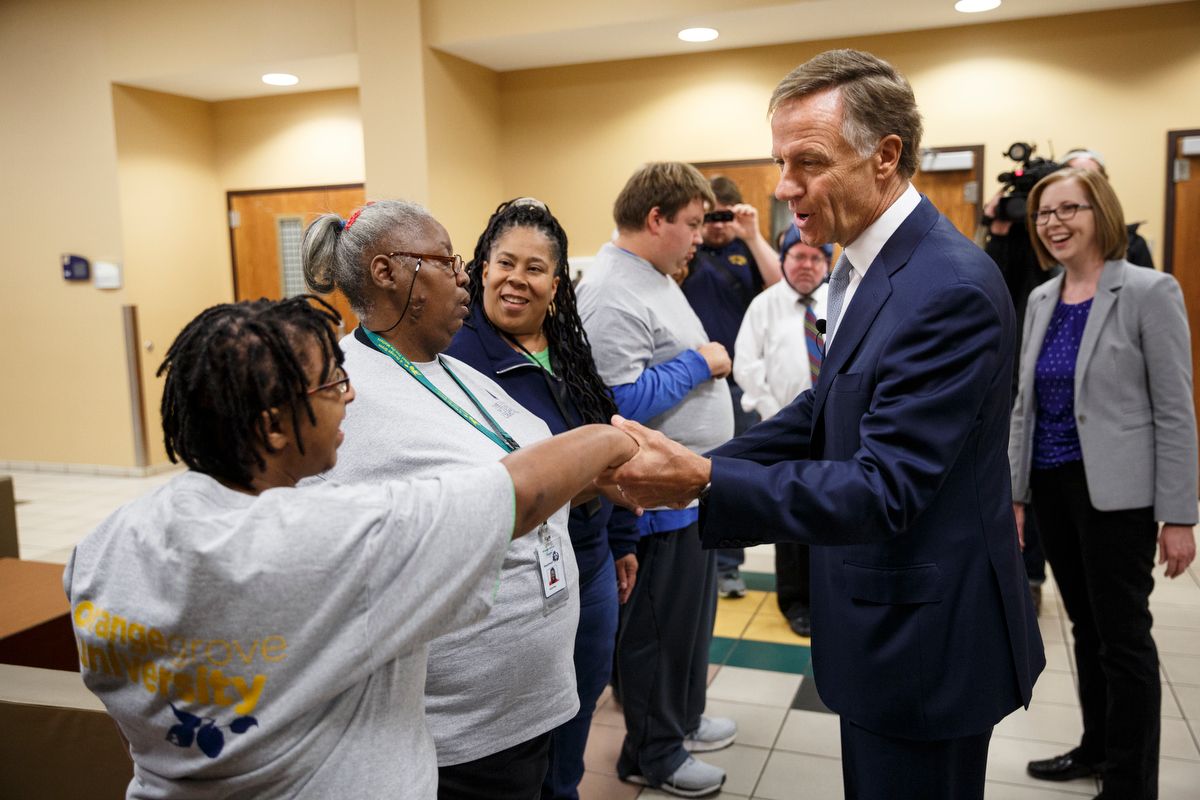 Gov. Bill Haslam shakes hands with Trisha Franklin, left, during a visit to the campus of the University of Tennessee at Chattanooga on Thursday, Nov. 8, 2018, in Chattanooga, Tenn. Gov. Haslam released the fifth annual report by the Employment First Task Force during the visit, which shows the task force's efforts to increase employment for people with disabilities.