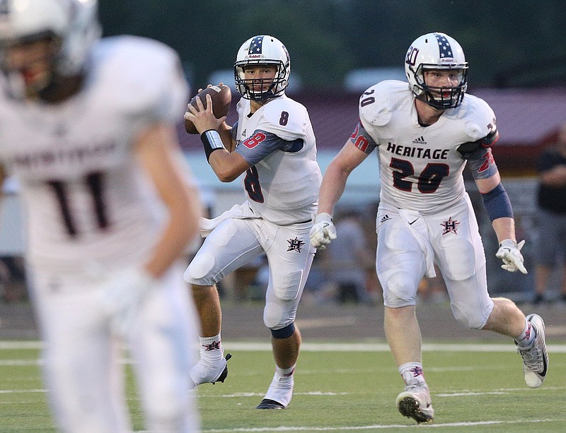 Heritage quarterback Nick Hanson, center, looks to throw as Jeffery Curtis, right, provides pass protection during the Generals' game at Ridgeland on Sept. 21.