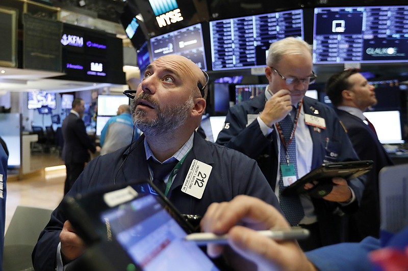 Trader Vincent Napolitano, left, works on the floor of the New York Stock Exchange, Friday, Nov. 9, 2018. Stocks are falling as energy companies are dragged lower by the continuing plunge in crude oil prices. (AP Photo/Richard Drew)