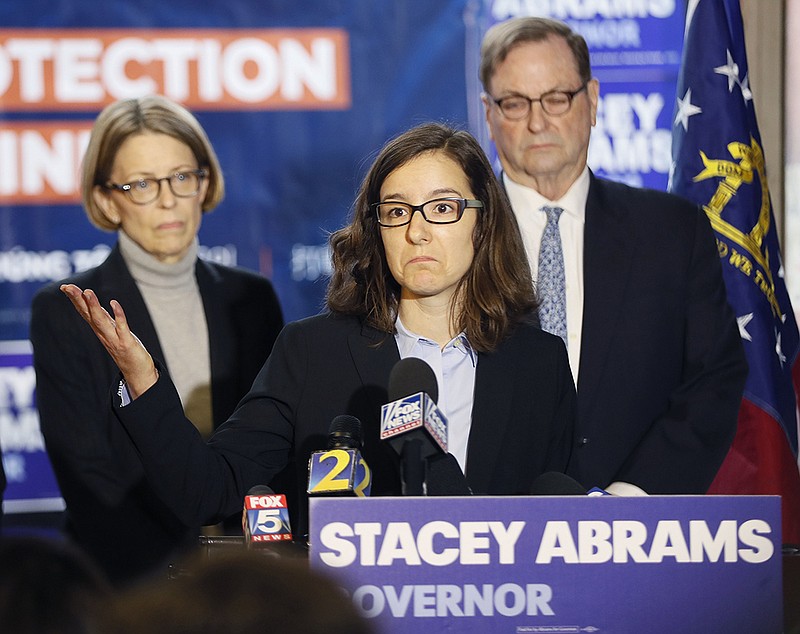 Lauren Groh-Wargo, Stacey Abrams' campaign manager, stands with attorneys at a news conference Thursday, Nov. 8, 2018, in Atlanta. Republican Brian Kemp resigned Thursday as Georgia's secretary of state, a day after his campaign said he's captured enough votes to become governor despite his rival's refusal to concede. Abrams' campaign immediately responded by refusing to accept Kemp's declaration of victory in the race and demanding that state officials "count every single vote." (Bob Andres/Atlanta Journal-Constitution via AP)

