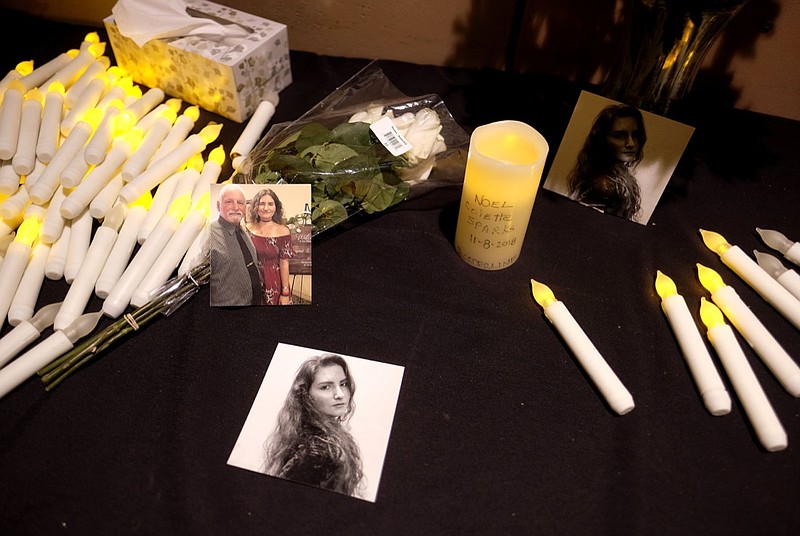 Pictures of Noel Sparks are seen during a candlelight vigil in Thousand Oaks , Calif., Thursday, Nov. 8, 2018. A gunman opened fire Wednesday evening inside a country music bar, killing multiple people. (AP Photo/Ringo H.W. Chiu)