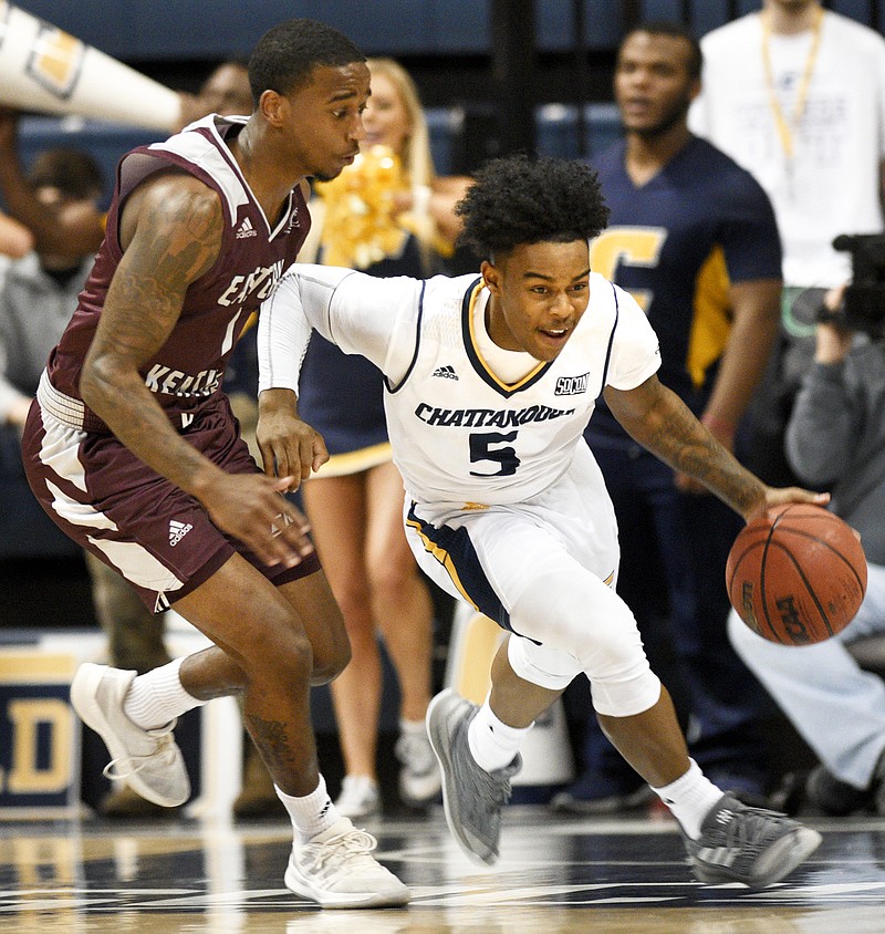 UTC's Donovann Toatley (5) attempts to break Eastern Kentucky's press as he dribbles past JacQuess Hobbs during Saturday night's game at McKenzie Arena.