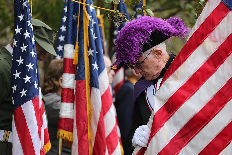 Raleigh Cooper places his flag during the Veterans Day Program Sunday, November 11, 2018 at the Chattanooga National Cemetery in Chattanooga, Tennessee. Cooper was with the Knights of Columbus and served in the United States Air Force. 