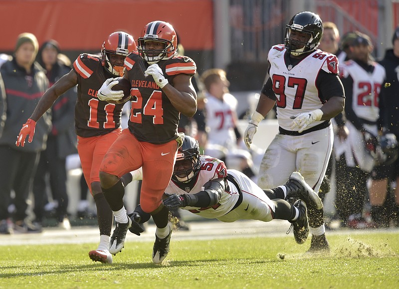 Cleveland Browns running back Nick Chubb (24) heads for the end zone and a 92-yard touchdown as Atlanta Falcons linebacker Foye Oluokun (54) misses the tackle during the second half of Sunday's game in Cleveland.
