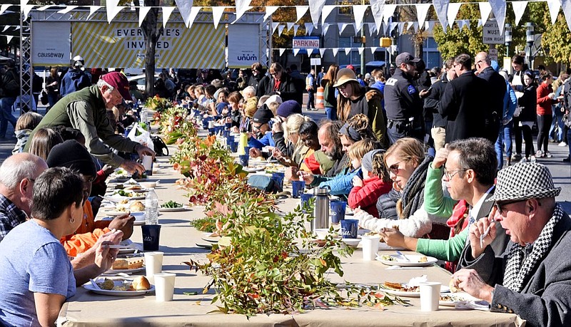 Staff Photo by Robin Rudd /
A large crowd feels the tables. Causeway held it's One Table Community Thanksgiving Potluck lunch in the middle of Martin Luther King Junior Boulevard in Chattanooga on November 21, 2016. Executive Director of Causeway, Abby Garrison was hoping for a record crowd for the free, collaborative meal.