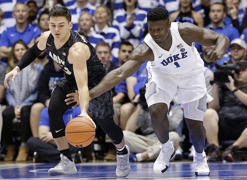 AP photo by Gerry Broome / Army's Tommy Funk, left, and Duke's Zion Williamson chase the basketball during the first half of their teams' matchup on Nov. 11, 2018, in Durham, N.C.