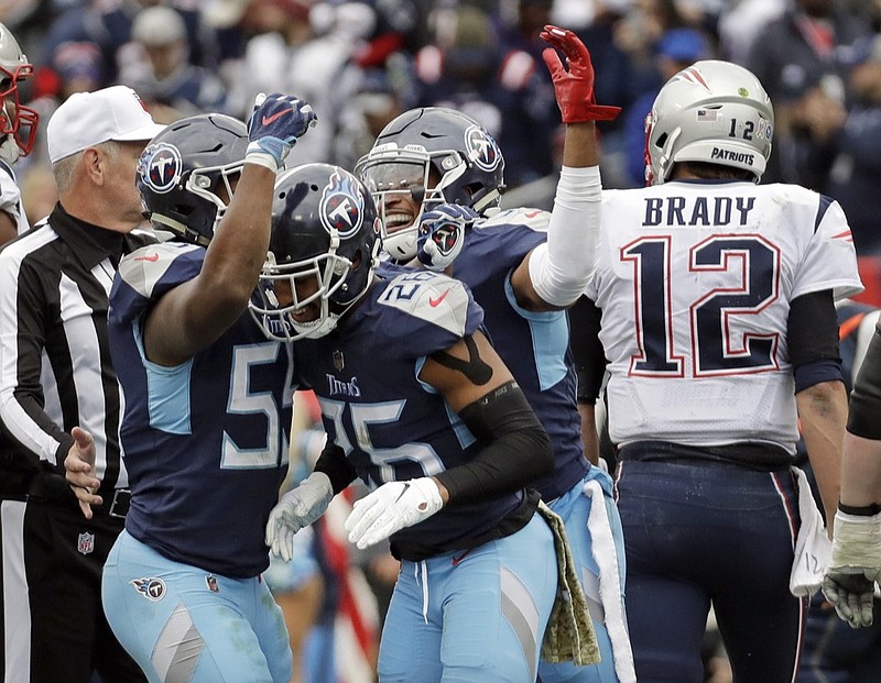 Tennessee Titans cornerback Logan Ryan (26) is congratulated after sacking New England Patriots quarterback Tom Brady (12) in the first half of an NFL football game Sunday, Nov. 11, 2018, in Nashville, Tenn. (AP Photo/James Kenney)

