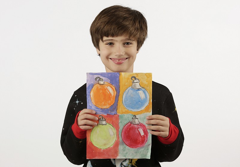 Ben Alverson poses with his winning wrapping paper design in last year's Lin C. Parker Wrapping Paper Design Contest.