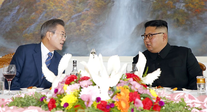 South Korean President Moon Jae-in, left, talks with North Korean leader Kim Jong Un at a restaurant in Pyongyang, North Korea, during negotiations between the two in September.