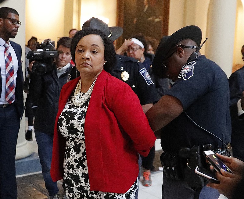 Sen. Nikema Williams (D-Atlanta) is arrested by capitol police during a protest over election ballot counts in the rotunda of the state capitol building Tuesday, Nov. 13, 2018, in Atlanta. Dozens filled the rotunda in the center of the Capitol's second floor Tuesday just as the House was scheduled to convene for a special session. (AP Photo/John Bazemore)

