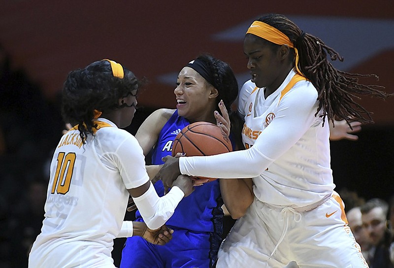 UNC Asheville guard Sonora Dengokl gets sandwiched by Tennessee's Meme Jackson and Cheridene Green during Wednesday night's game in Knoxville. The Lady Vols won 73-46.
