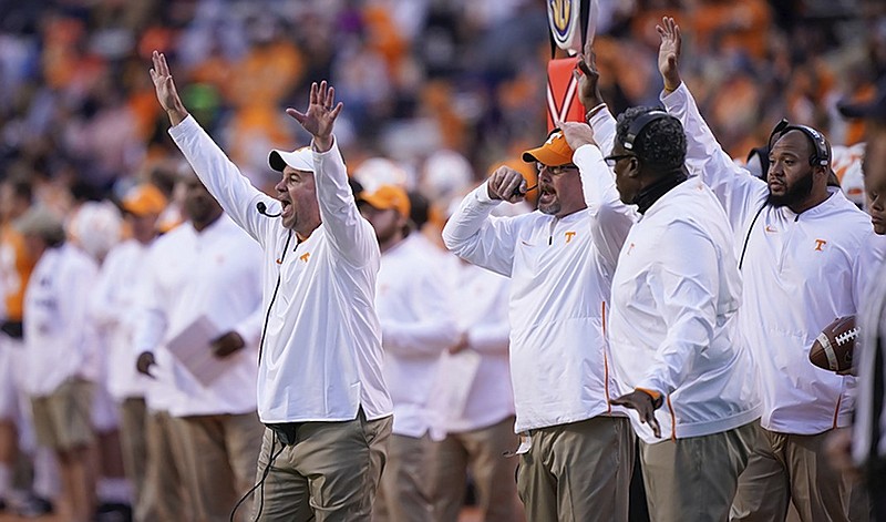 Tennessee football coach Jeremy Pruitt, left, and his assistants change a play call during the Vols' 14-3 win against Charlotte on Nov. 3 in Knoxville.