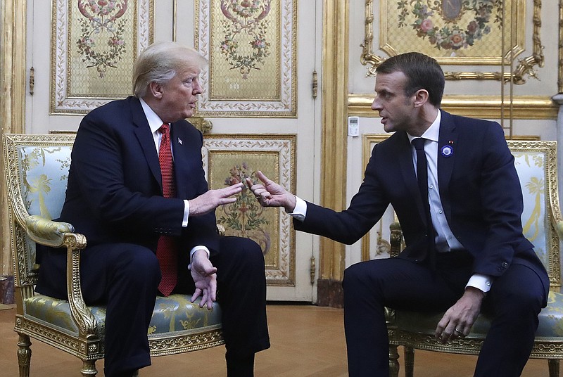 President Donald Trump and French President Emmanuel Macron gesture during their meeting inside the Elysee Palace in Paris last Saturday. Trump joined other world leaders at centennial commemorations in Paris this weekend to mark the end of World War I. (AP Photo/Jacquelyn Martin)