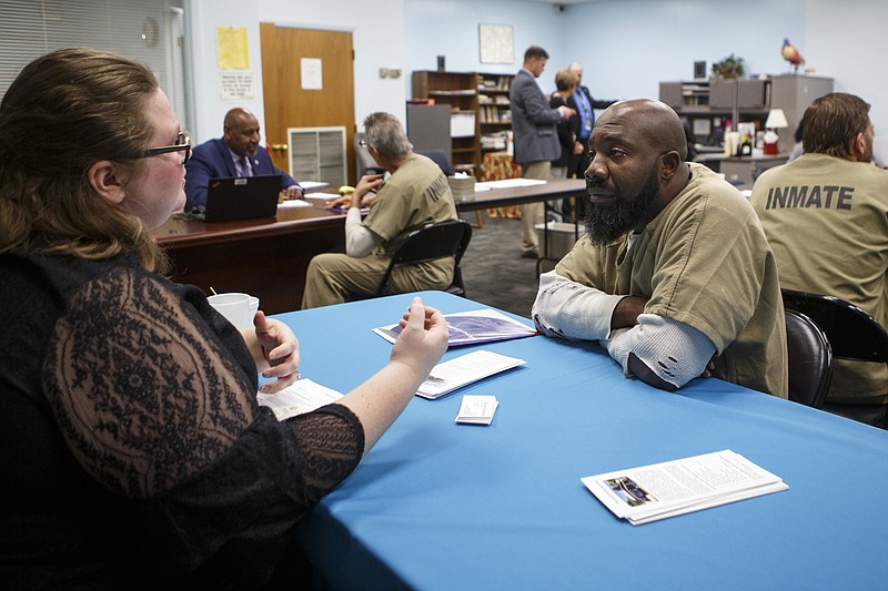 Terrence Jackson, right, speaks with Paige Snell, the program director/clinician for The Transition House of Tennessee, during a job fair at the Silverdale Detention Center on Wednesday, Nov. 14, 2018 in Chattanooga, Tenn.