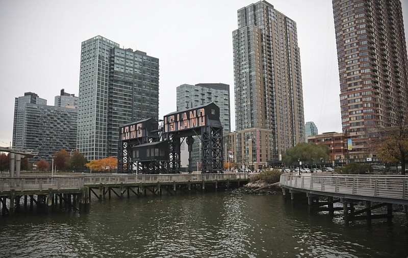 A former dock facility is shown with old transfer bridges, with "Long Island" painted in large letters at Gantry State Park in the Long Island City section of Queens, N.Y., Tuesday Nov. 13, 2018, in New York. Amazon announced Tuesday it has selected the Queens neighborhood as one of two sites for its headquarters. (AP Photo/Bebeto Matthews)
