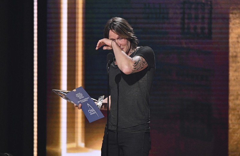 Keith Urban wipes away tears as he accepts the award for entertainer of the year at the 52nd annual CMA Awards at Bridgestone Arena on Wednesday, Nov. 14, 2018, in Nashville, Tenn. (Photo by Charles Sykes/Invision/AP)

