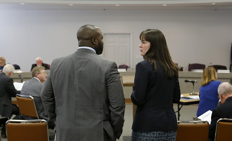 Superintendent Bryan Johnson, left, and Education Commissioner Candice McQueen talk before a work session at Hamilton County Schools' central office on Thursday, Feb. 8, 2018 in Chattanooga, Tenn. McQueen presented the state's plan to help the district's historically failing schools.