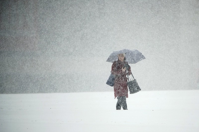 A person walks across Independence Mall during a snow storm in Philadelphia, Thursday, Nov. 15, 2018. (AP Photo/Matt Rourke)

