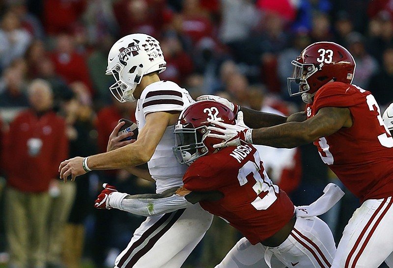 Alabama linebackers Dylan Moses (32) and Anfernee Jennings (33) sack Mississippi State quarterback Nick Fitzgerald during last Saturday's game in Tuscaloosa, Ala.