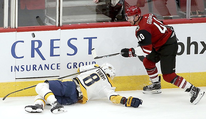 Arizona Coyotes right wing Michael Grabner, right, gets the puck past Nashville Predators center Kyle Turris during the second period of Thursday night's game in Glendale, Ariz.