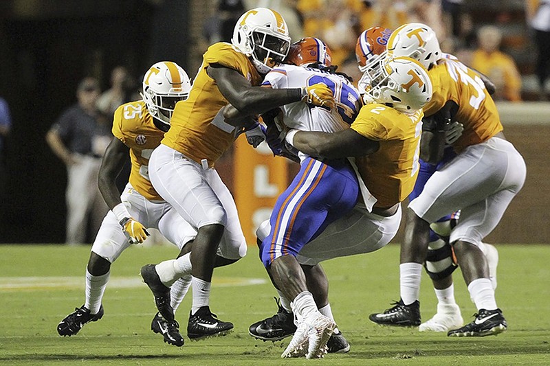 Tennessee linebacker Will Ignont, left, and defensive lineman Shy Tuttle sandwich Florida running back Jordan Scarlett during the SEC East rivals' Sept. 22 matchup at Neyland Stadium in Knoxville. Tuttle is among the 13 seniors who will he honored Saturday at the Vols' home finale as Missouri visits.